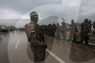 Heavily armed Hamas fighters attend handover of Israeli hostages