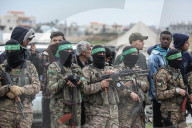 Heavily armed Hamas fighters attend handover of Israeli hostages