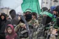 Heavily armed Hamas fighters attend handover of Israeli hostages
