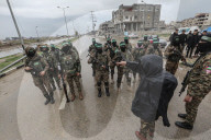 Heavily armed Hamas fighters attend handover of Israeli hostages