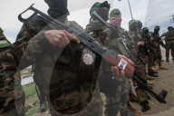 Heavily armed Hamas fighters attend handover of Israeli hostages