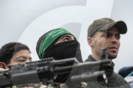Heavily armed Hamas fighters attend handover of Israeli hostages