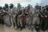 Heavily armed Hamas fighters attend handover of Israeli hostages