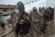 Heavily armed Hamas fighters attend handover of Israeli hostages