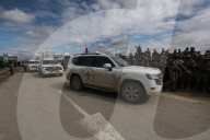 Heavily armed Hamas fighters attend handover of Israeli hostages