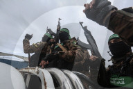 Heavily armed Hamas fighters attend handover of Israeli hostages