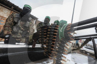 Heavily armed Hamas fighters attend handover of Israeli hostages