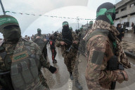 Heavily armed Hamas fighters attend handover of Israeli hostages