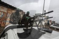 Heavily armed Hamas fighters attend handover of Israeli hostages