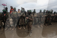 Heavily armed Hamas fighters attend handover of Israeli hostages