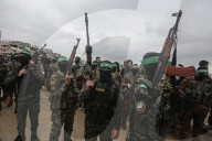 Heavily armed Hamas fighters attend handover of Israeli hostages