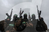 Heavily armed Hamas fighters attend handover of Israeli hostages