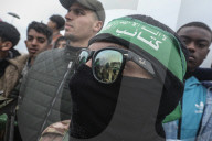 Heavily armed Hamas fighters attend handover of Israeli hostages
