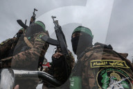 Heavily armed Hamas fighters attend handover of Israeli hostages
