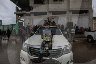 Heavily armed Hamas fighters attend handover of Israeli hostages