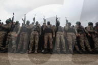 Heavily armed Hamas fighters attend handover of Israeli hostages