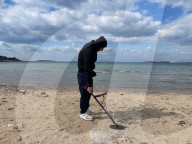 Beachcombing with metal detector on Athens beaches