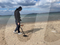 Beachcombing with metal detector on Athens beaches