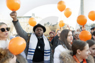 Orange balloons are released over Trafalgar Square in memory & honour of the Bibas family, London, UK.