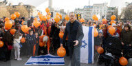 Orange balloons are released over Trafalgar Square in memory & honour of the Bibas family, London, UK.