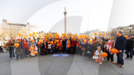 Orange balloons are released over Trafalgar Square in memory & honour of the Bibas family, London, UK.