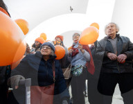 Orange balloons are released over Trafalgar Square in memory & honour of the Bibas family, London, UK.