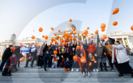 Orange balloons are released over Trafalgar Square in memory & honour of the Bibas family, London, UK.