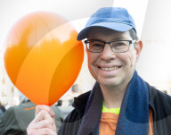 Orange balloons are released over Trafalgar Square in memory & honour of the Bibas family, London, UK.