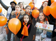 Orange balloons are released over Trafalgar Square in memory & honour of the Bibas family, London, UK.