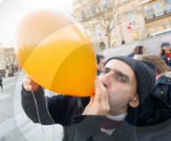 Orange balloons are released over Trafalgar Square in memory & honour of the Bibas family, London, UK.