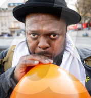 Orange balloons are released over Trafalgar Square in memory & honour of the Bibas family, London, UK.