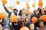 Orange balloons are released over Trafalgar Square in memory & honour of the Bibas family, London, UK.