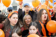 Orange balloons are released over Trafalgar Square in memory & honour of the Bibas family, London, UK.