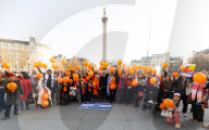Orange balloons are released over Trafalgar Square in memory & honour of the Bibas family, London, UK.