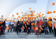 Orange balloons are released over Trafalgar Square in memory & honour of the Bibas family, London, UK.