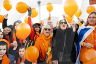 Orange balloons are released over Trafalgar Square in memory & honour of the Bibas family, London, UK.