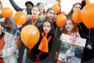Orange balloons are released over Trafalgar Square in memory & honour of the Bibas family, London, UK.
