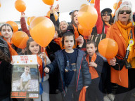 Orange balloons are released over Trafalgar Square in memory & honour of the Bibas family, London, UK.