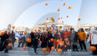 Orange balloons are released over Trafalgar Square in memory & honour of the Bibas family, London, UK.