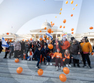 Orange balloons are released over Trafalgar Square in memory & honour of the Bibas family, London, UK.