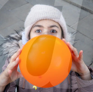 Orange balloons are released over Trafalgar Square in memory & honour of the Bibas family, London, UK.