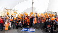 Orange balloons are released over Trafalgar Square in memory & honour of the Bibas family, London, UK.