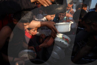 Palestinian Children Receive Iftar Meal at Gaza City Distribution Point During Ramadan