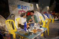 Hostage families hold Shabbat dinner facing army headquarters