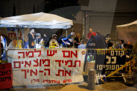 Hostage families hold Shabbat dinner facing army headquarters