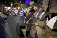 Hostage families hold Shabbat dinner facing army headquarters