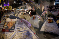 Hostage families hold Shabbat dinner facing army headquarters