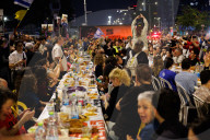 Hostage families hold Shabbat dinner facing army headquarters