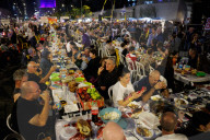 Hostage families hold Shabbat dinner facing army headquarters