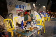 Hostage families hold Shabbat dinner facing army headquarters